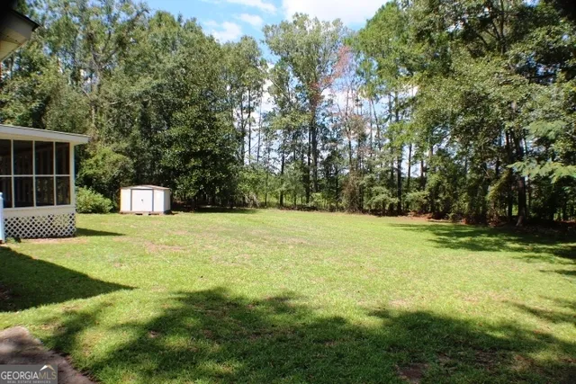 a yellow house with trees in front of it