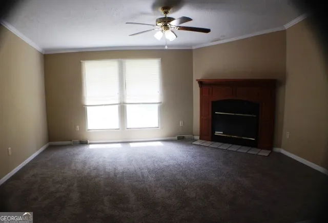 a view of empty room with a fireplace