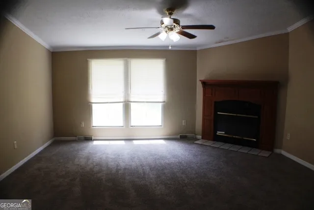 a view of empty room with a fireplace