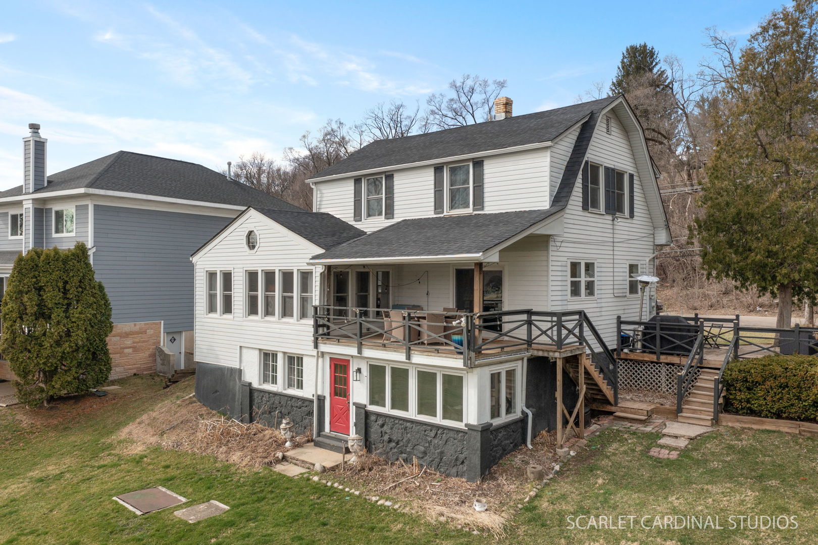705 Spring Beach Way Cary, IL 60013 - Photo 21 of 32 a view of a white house with large trees and windows