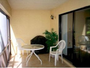 990 8th Street South, Unit 1 Naples, FL 34102 - Photo 2 of 10 a balcony with table and chairs