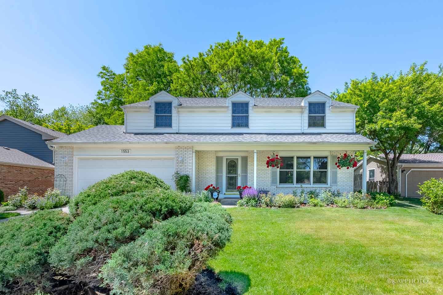front view of a house with a yard