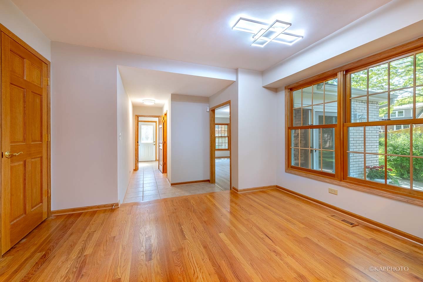 1553 Aztec Circle Naperville, IL 60563 - Photo 17 of 45 a view of an empty room with wooden floor and a window