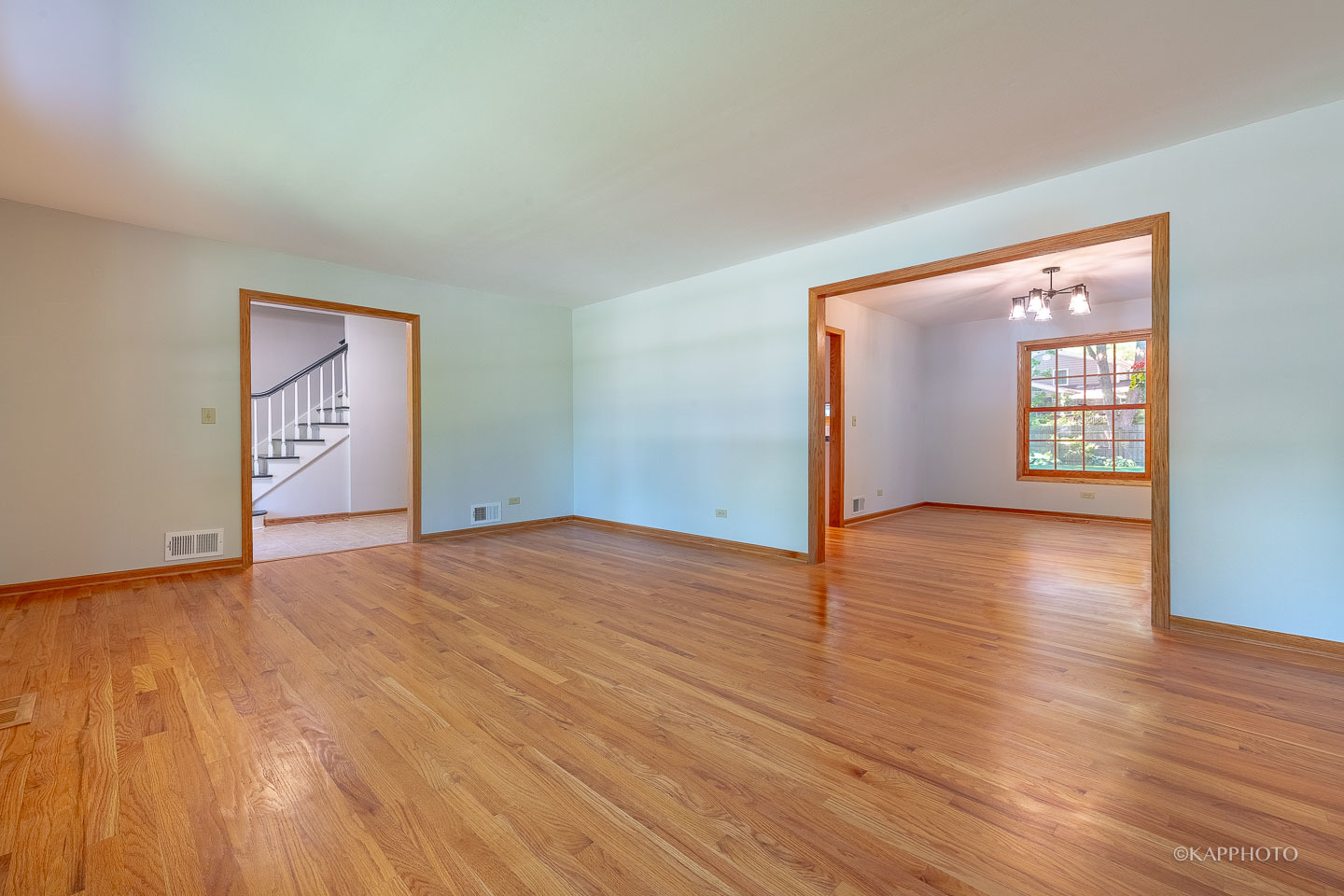1553 Aztec Circle Naperville, IL 60563 - Photo 7 of 45 a view of an empty room and window with wooden floor