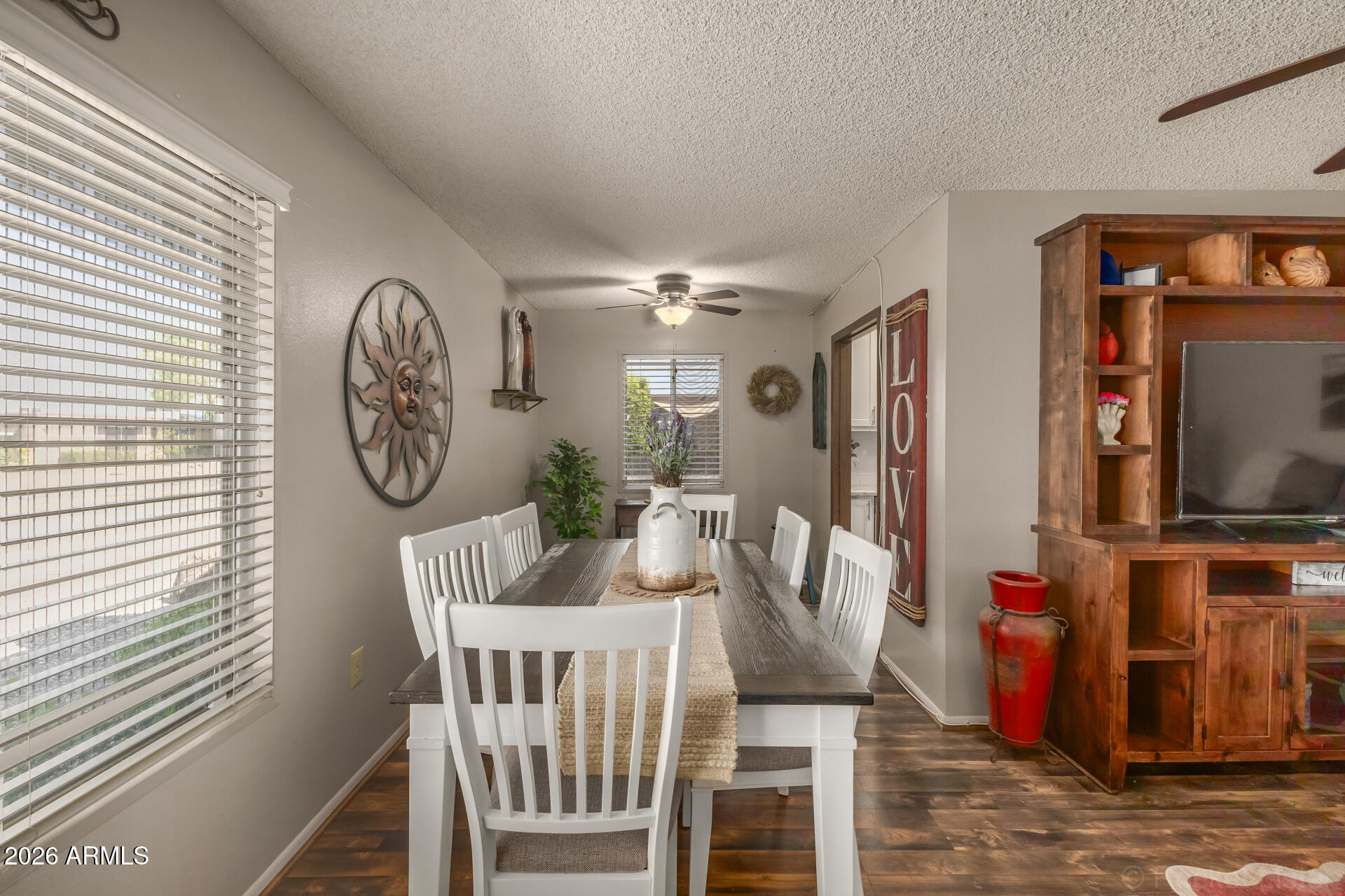 9845 West Royal Ridge Drive Sun City, AZ 85351 - Photo 11 of 28 a view of a dining room with furniture window and wooden floor