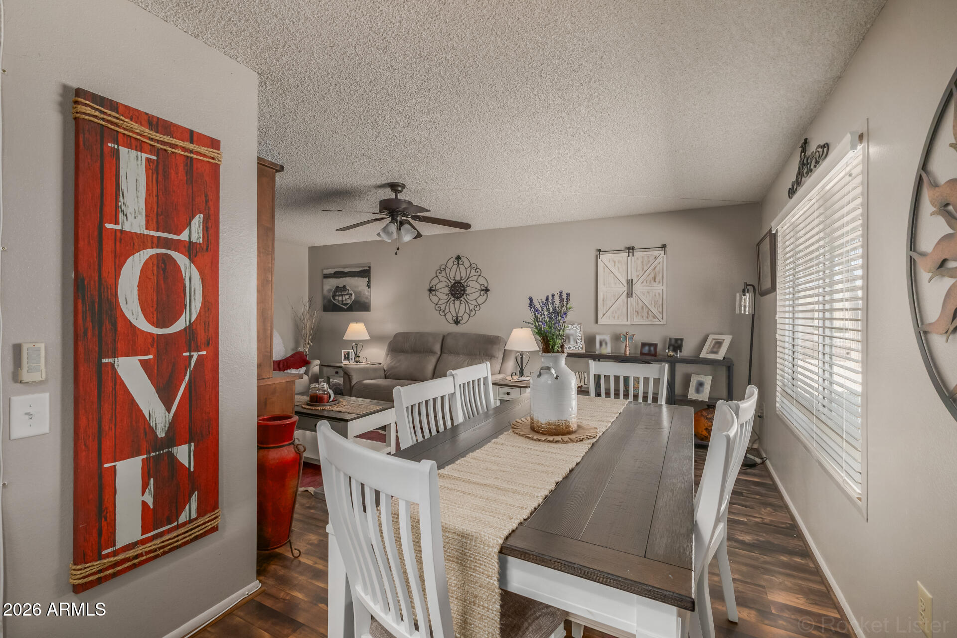 9845 West Royal Ridge Drive Sun City, AZ 85351 - Photo 12 of 28 a view of a dining room with furniture and chandelier
