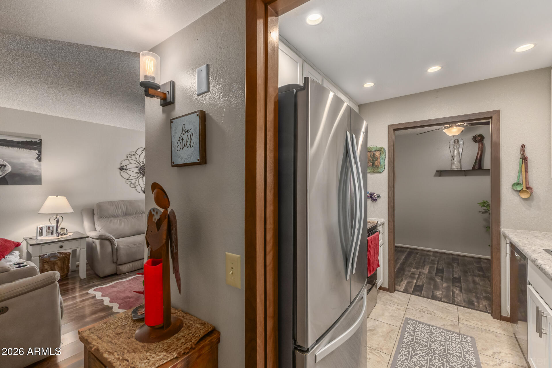 9845 West Royal Ridge Drive Sun City, AZ 85351 - Photo 15 of 28 a bathroom with a mirror and a shower