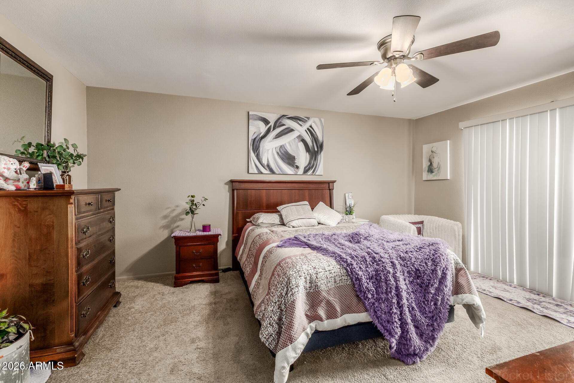 9845 West Royal Ridge Drive Sun City, AZ 85351 - Photo 17 of 28 a bedroom with a bed and a chandelier