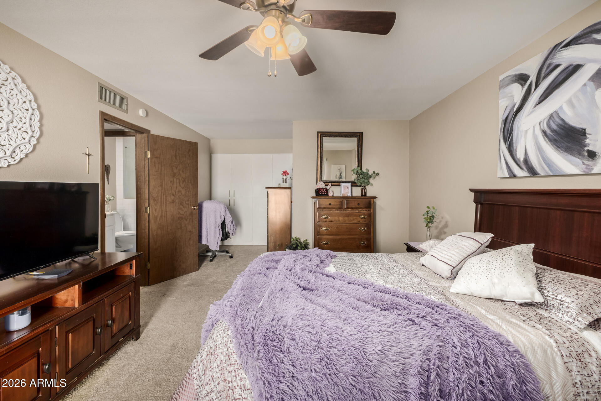 9845 West Royal Ridge Drive Sun City, AZ 85351 - Photo 19 of 28 a bedroom with a bed and a flat screen tv