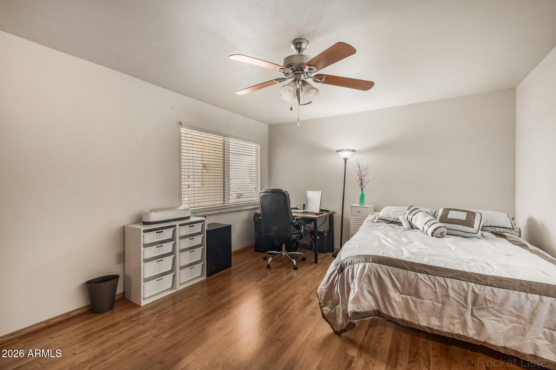 9845 West Royal Ridge Drive Sun City, AZ 85351 - Photo 22 of 28 a bedroom with a bed and a chandelier
