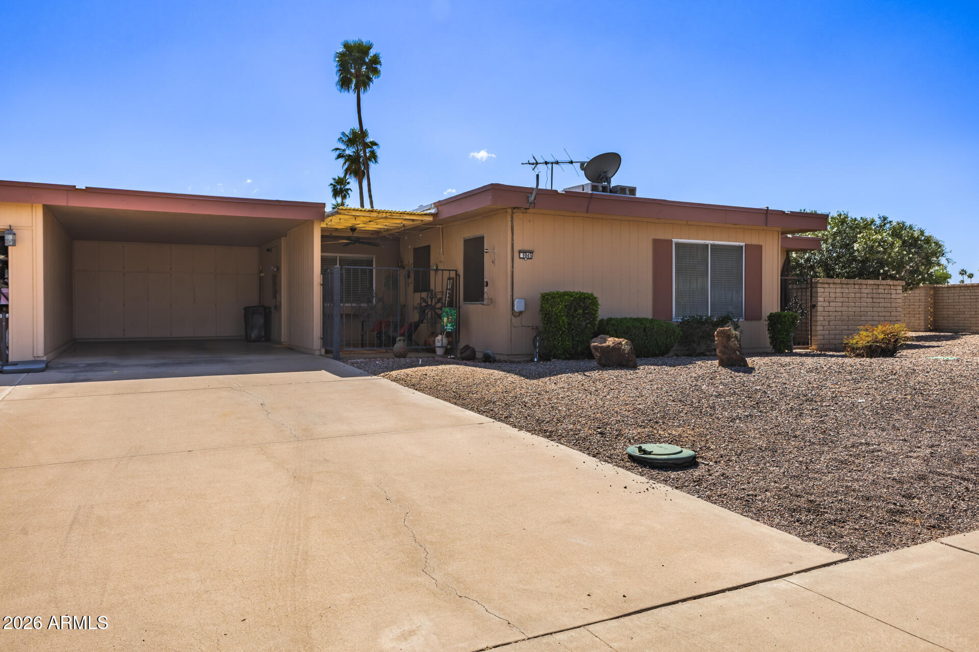 9845 West Royal Ridge Drive Sun City, AZ 85351 - Photo 5 of 28 a front view of a house with a yard