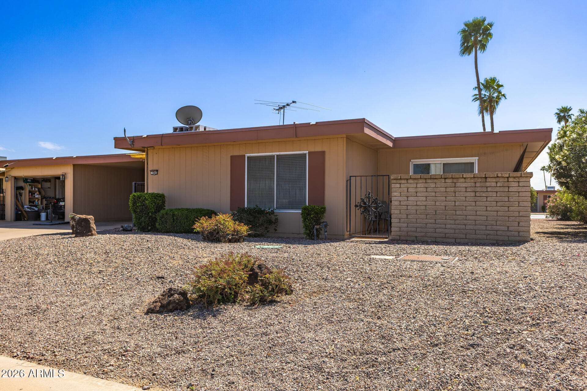 9845 West Royal Ridge Drive Sun City, AZ 85351 - Photo 6 of 28 a front view of a house with a yard