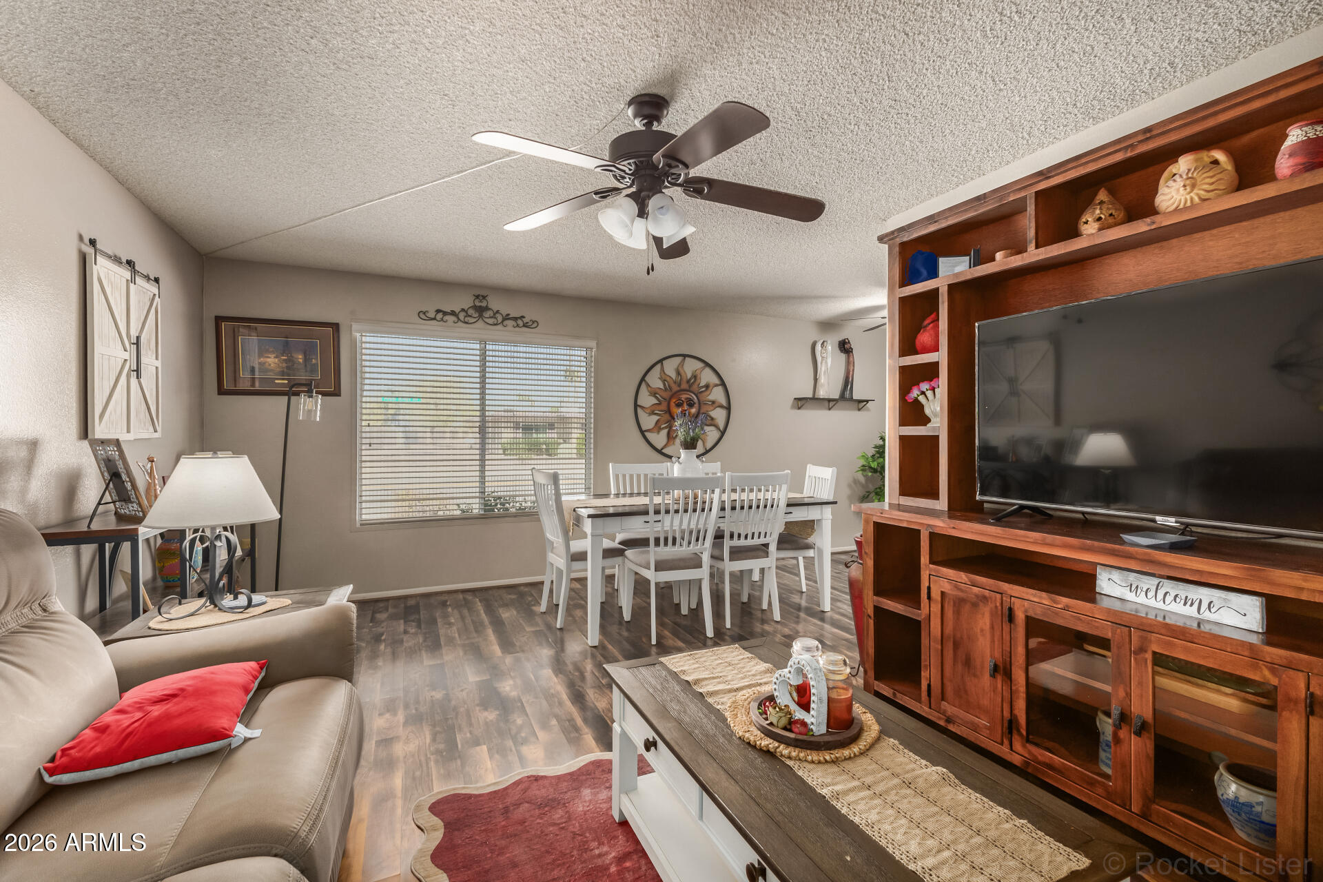 9845 West Royal Ridge Drive Sun City, AZ 85351 - Photo 9 of 28 a living room with furniture and a flat screen tv