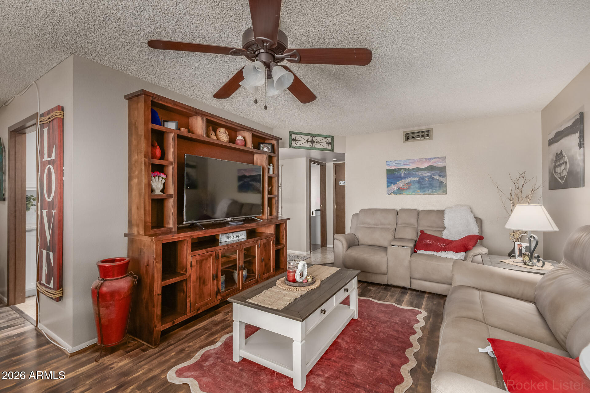 9845 West Royal Ridge Drive Sun City, AZ 85351 - Photo 10 of 28 a living room with furniture and a flat screen tv