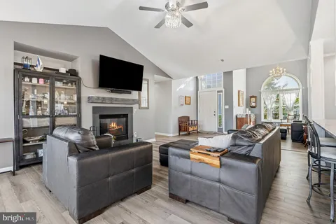 a dining table with chairs and kitchen view