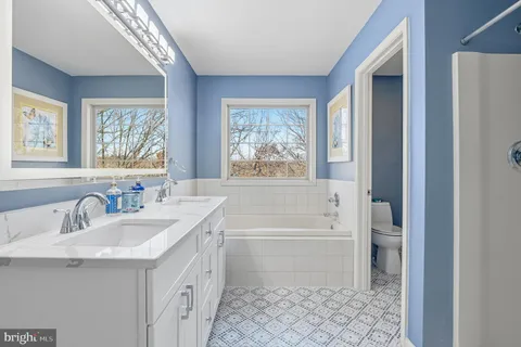 a bathroom with a toilet and shower curtain