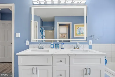 a bathroom with a sink toilet and mirror