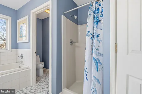 a bedroom with a bed and glass window