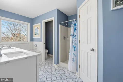 a bedroom with a bed and large windows