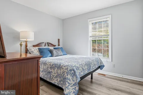 a view of a dining room with furniture wooden floor and a flat screen tv