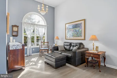 a living room with furniture and large windows