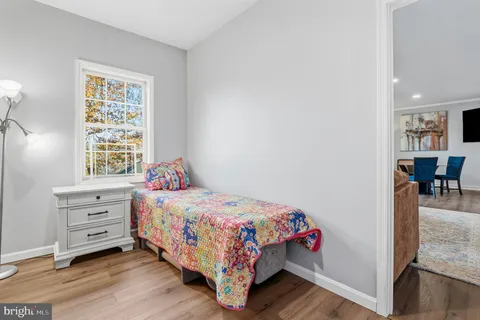 a kitchen with stainless steel appliances granite countertop a refrigerator a stove and a wooden cabinets with wooden floor