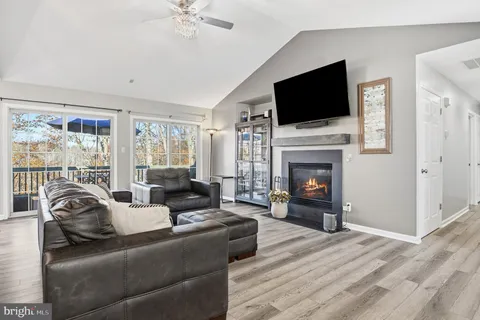 a living room with fireplace furniture and a flat screen tv