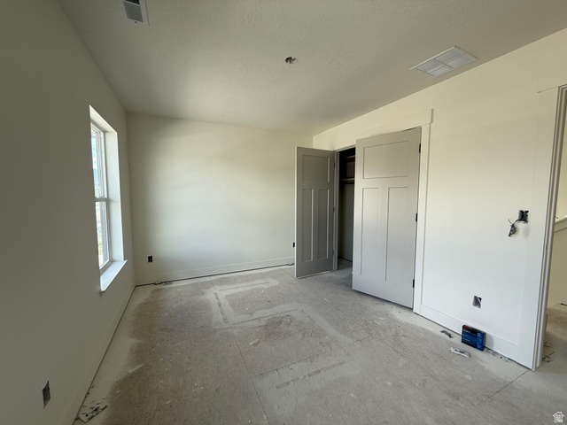 1008 West 3410 South Nibley, UT 84321 - Photo 17 of 26 Room featuring light-toned walls, a double-pane window, and two paneled doors with three horizontal sections