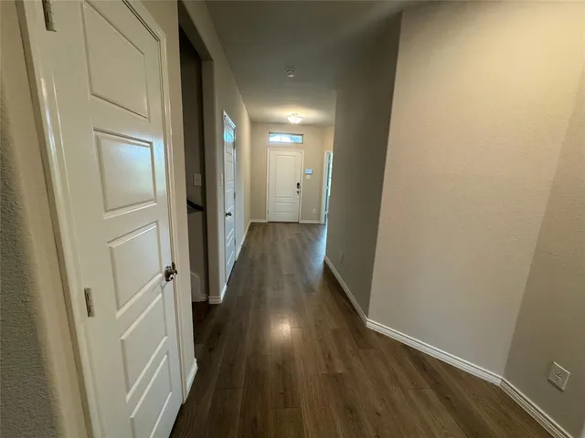 a view of hallway with wooden floor