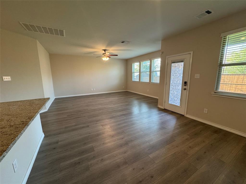 940 Azure Lane Celina, TX 75009 - Photo 17 of 26 an empty room with wooden floor and windows
