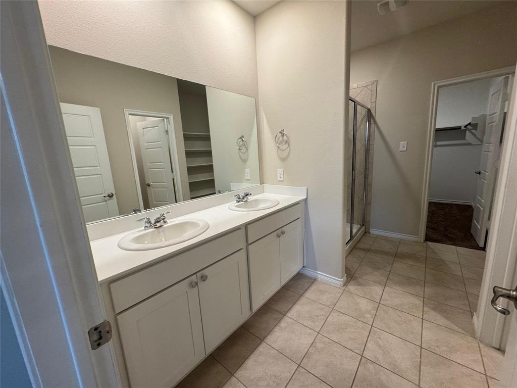 940 Azure Lane Celina, TX 75009 - Photo 21 of 26 a bathroom with a double vanity sink a and mirror