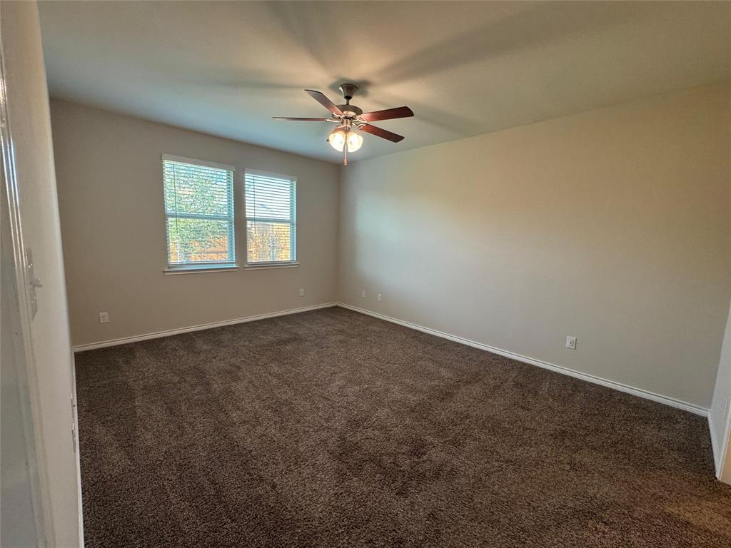 940 Azure Lane Celina, TX 75009 - Photo 24 of 26 an empty room with windows and fan