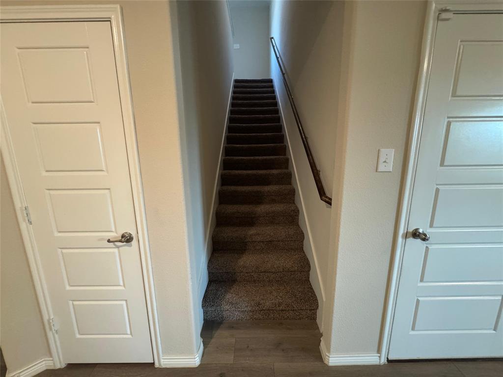 940 Azure Lane Celina, TX 75009 - Photo 26 of 26 a view of hallway with stairs and wooden floor