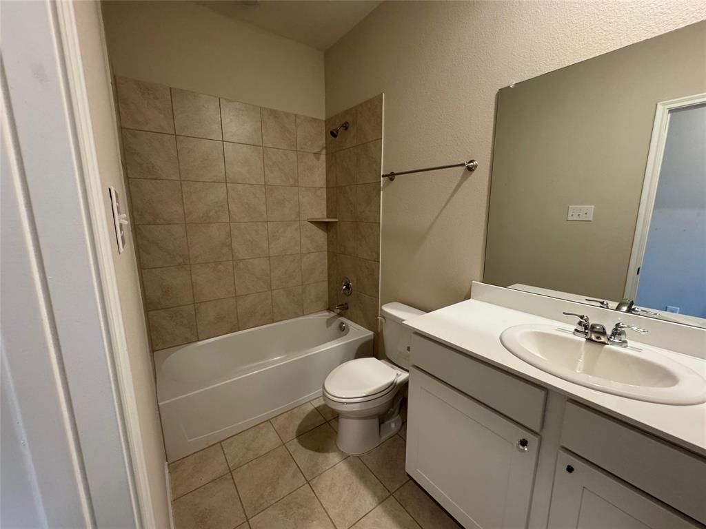 940 Azure Lane Celina, TX 75009 - Photo 7 of 26 a bathroom with a sink a toilet and shower