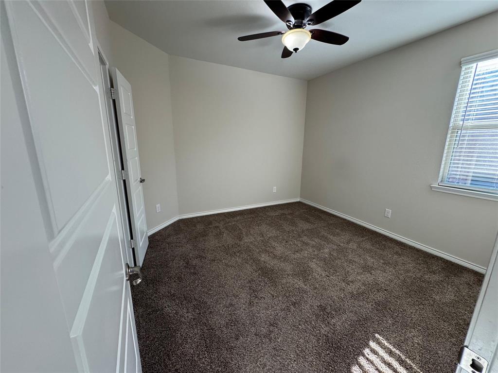 940 Azure Lane Celina, TX 75009 - Photo 9 of 26 wooden floor in an empty room with a window