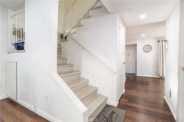 a view of entryway and hall with wooden floor