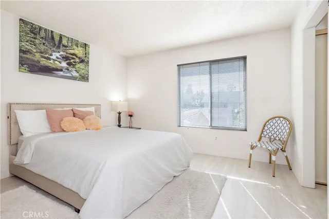 a bedroom with a bed and a painting on the wall