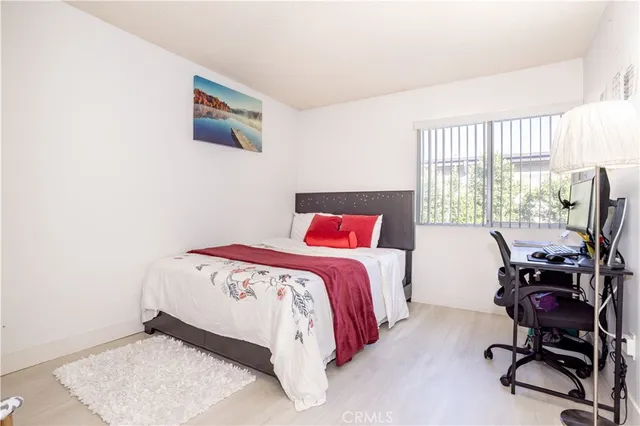 a bedroom with a bed and a desk