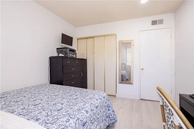 a bedroom with a bed and a dresser