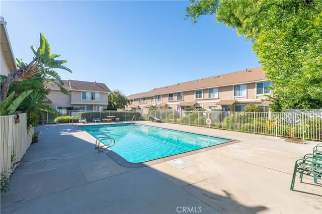 a view of a house with backyard and a tree