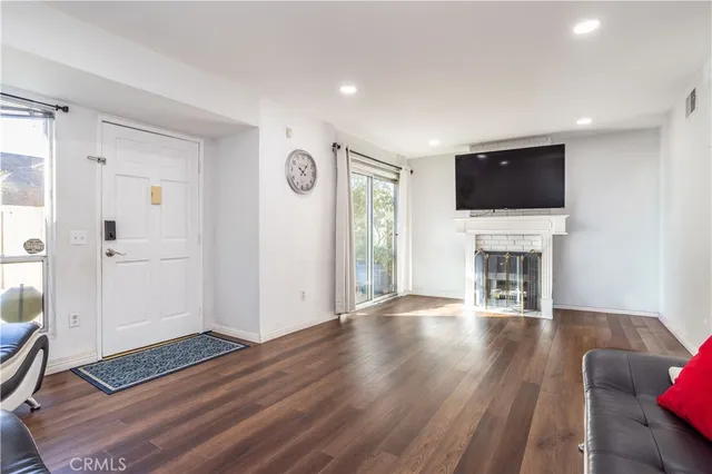 a view of livingroom with furniture fireplace and wooden floor