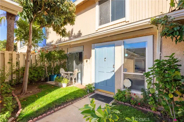 a view of a house with backyard sitting area and garden