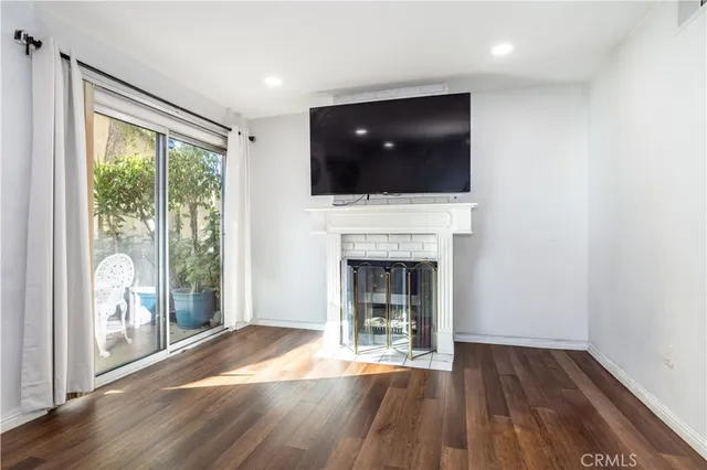 a living room with a fireplace and a flat screen tv