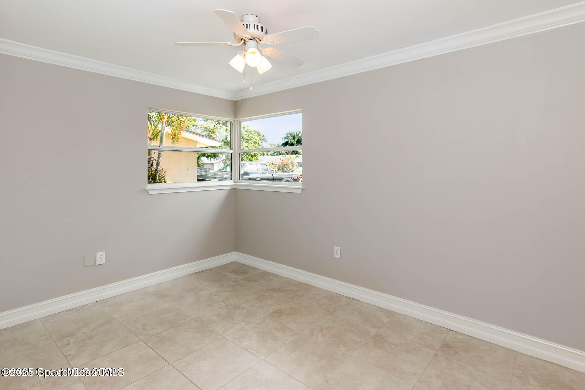 2360 Apache Drive Melbourne, FL 32935 - Photo 8 of 13 an empty room with windows and fan