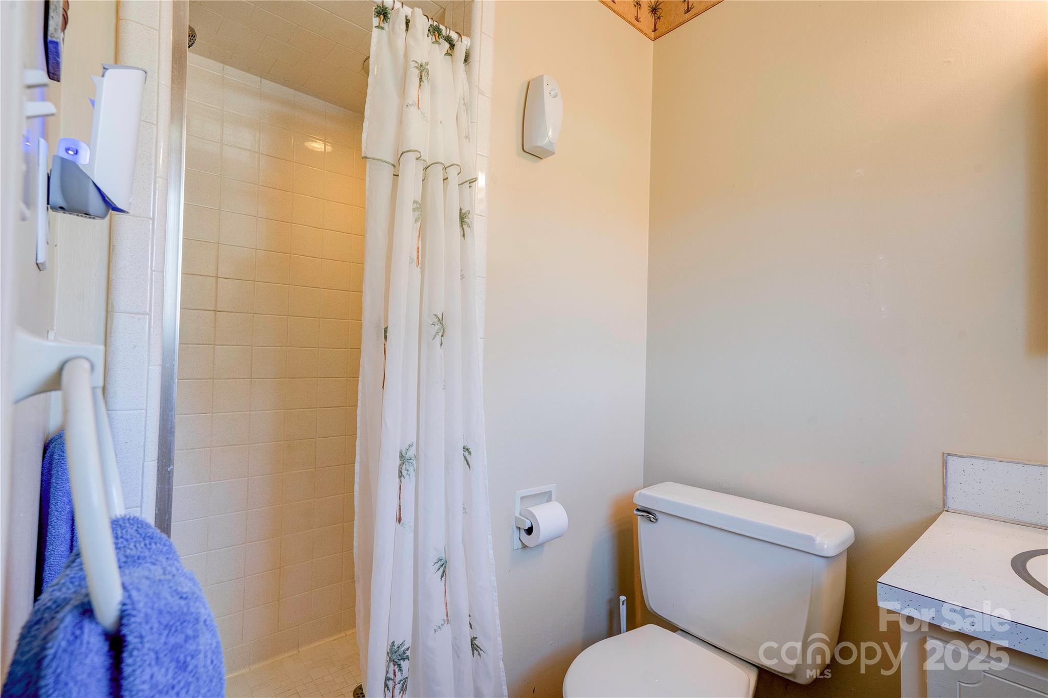 914 Parkwood Road Shelby, NC 28150 - Photo 13 of 40 a white toilet sitting next to a bathroom sink and a shower