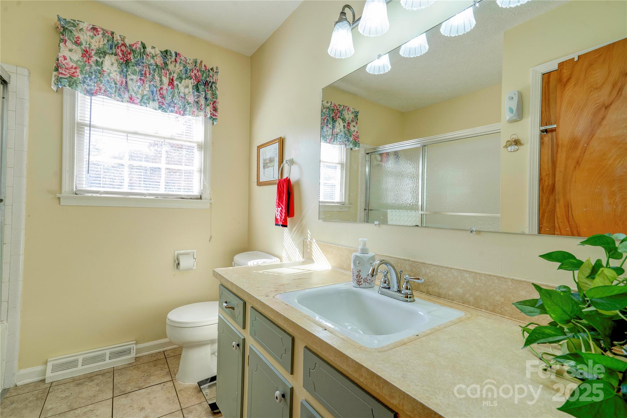 914 Parkwood Road Shelby, NC 28150 - Photo 19 of 40 a bathroom with a granite countertop sink and a mirror