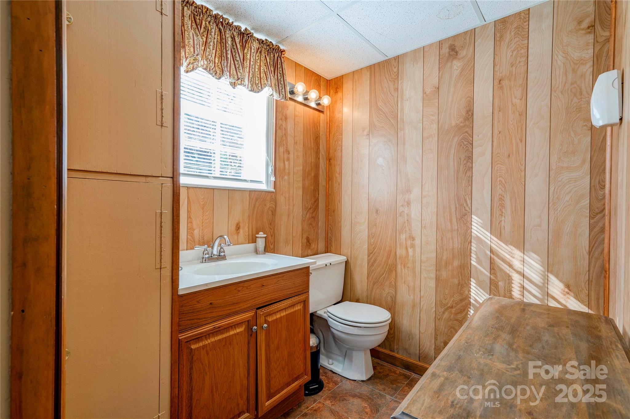 914 Parkwood Road Shelby, NC 28150 - Photo 26 of 40 a bathroom with a sink a toilet and shower curtain