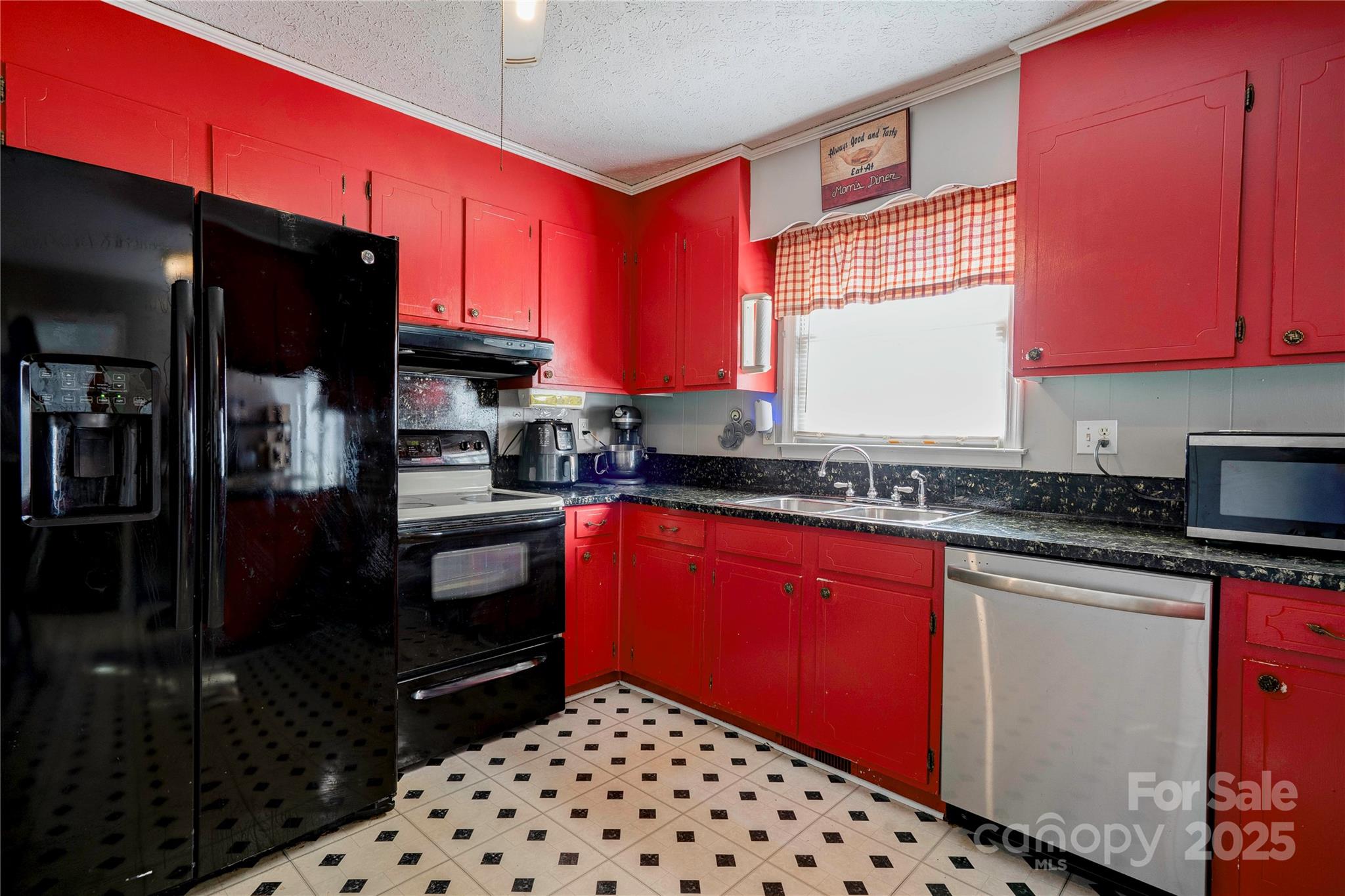 914 Parkwood Road Shelby, NC 28150 - Photo 7 of 40 a kitchen with stainless steel appliances a microwave a stove and red cabinets