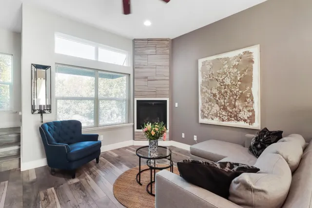 a dining room with furniture a chandelier and wooden floor
