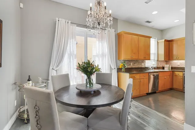 a kitchen with stainless steel appliances granite countertop a refrigerator a stove top oven a sink and dishwasher